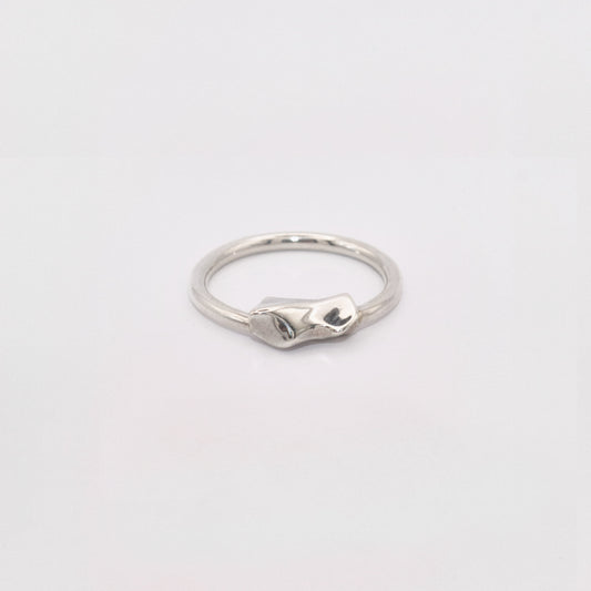 Silver ring on a light gray background