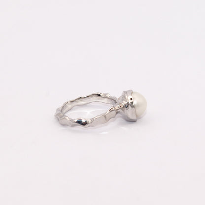Silver ring with a pearl on a white background