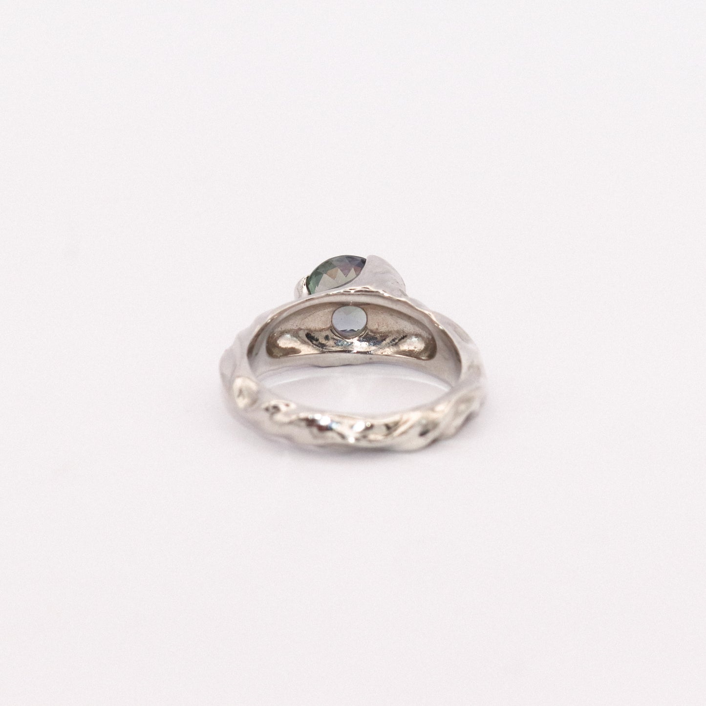 Silver ring with a heart-shaped gemstone on a white background