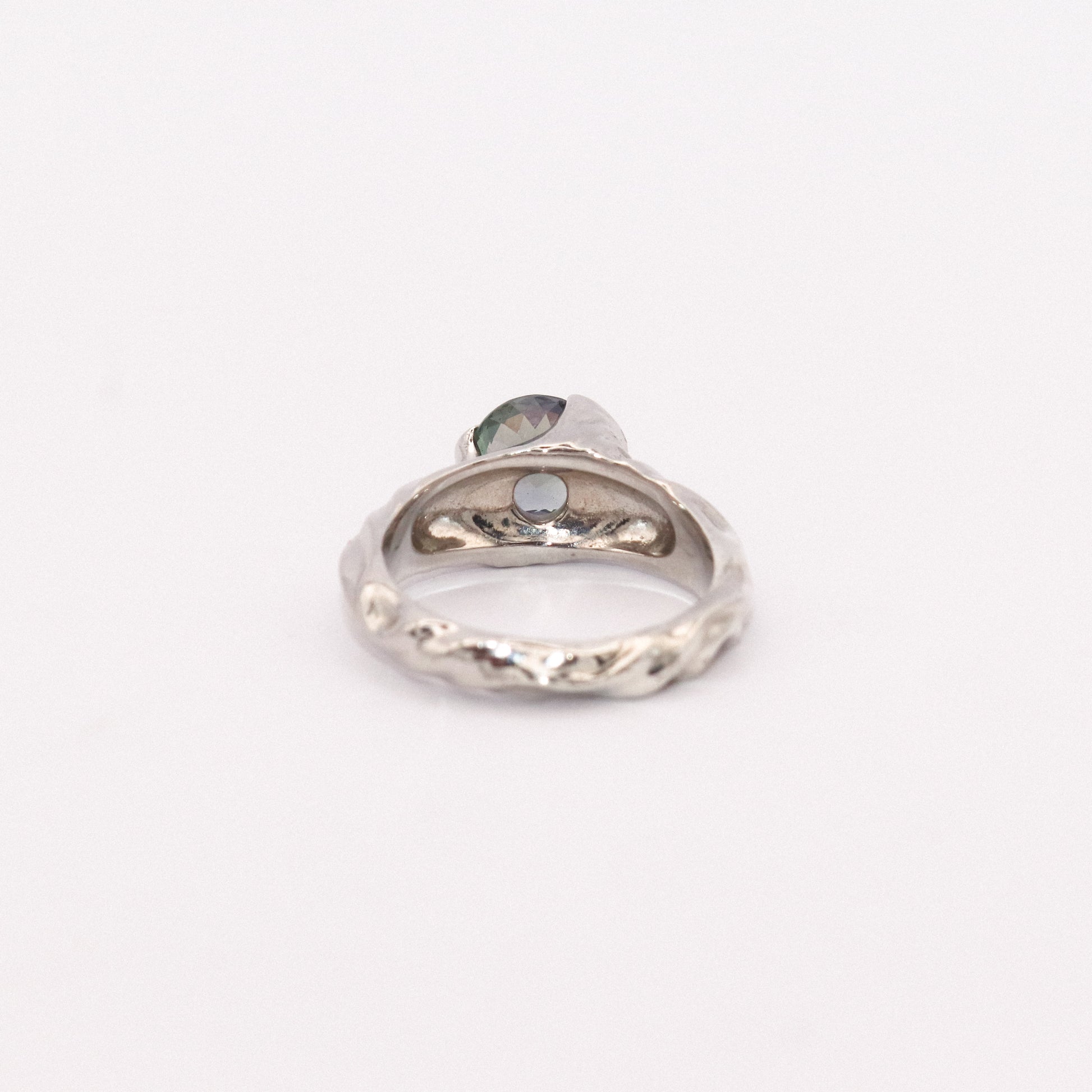 Silver ring with a heart-shaped gemstone on a white background