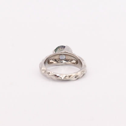 Silver ring with a heart-shaped gemstone on a white background