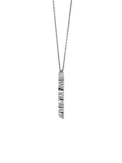 A sterling silver pendant with a wave design, suspended from a chain.