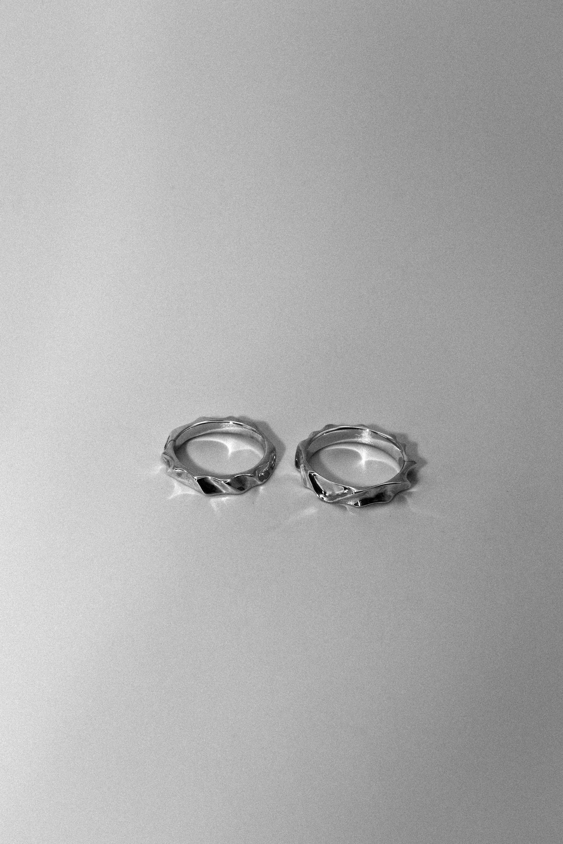 Pair of silver hoop earrings on a gray background