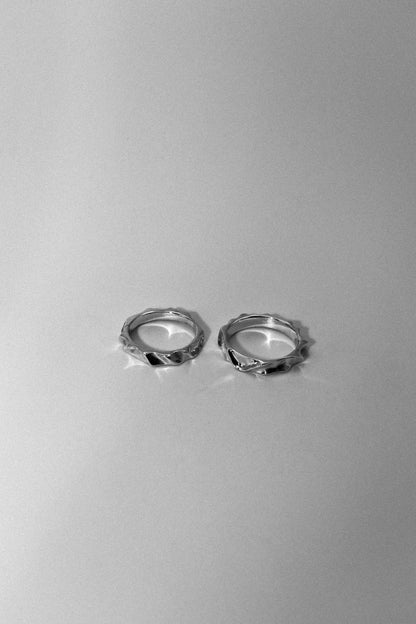 Pair of silver hoop earrings on a gray background