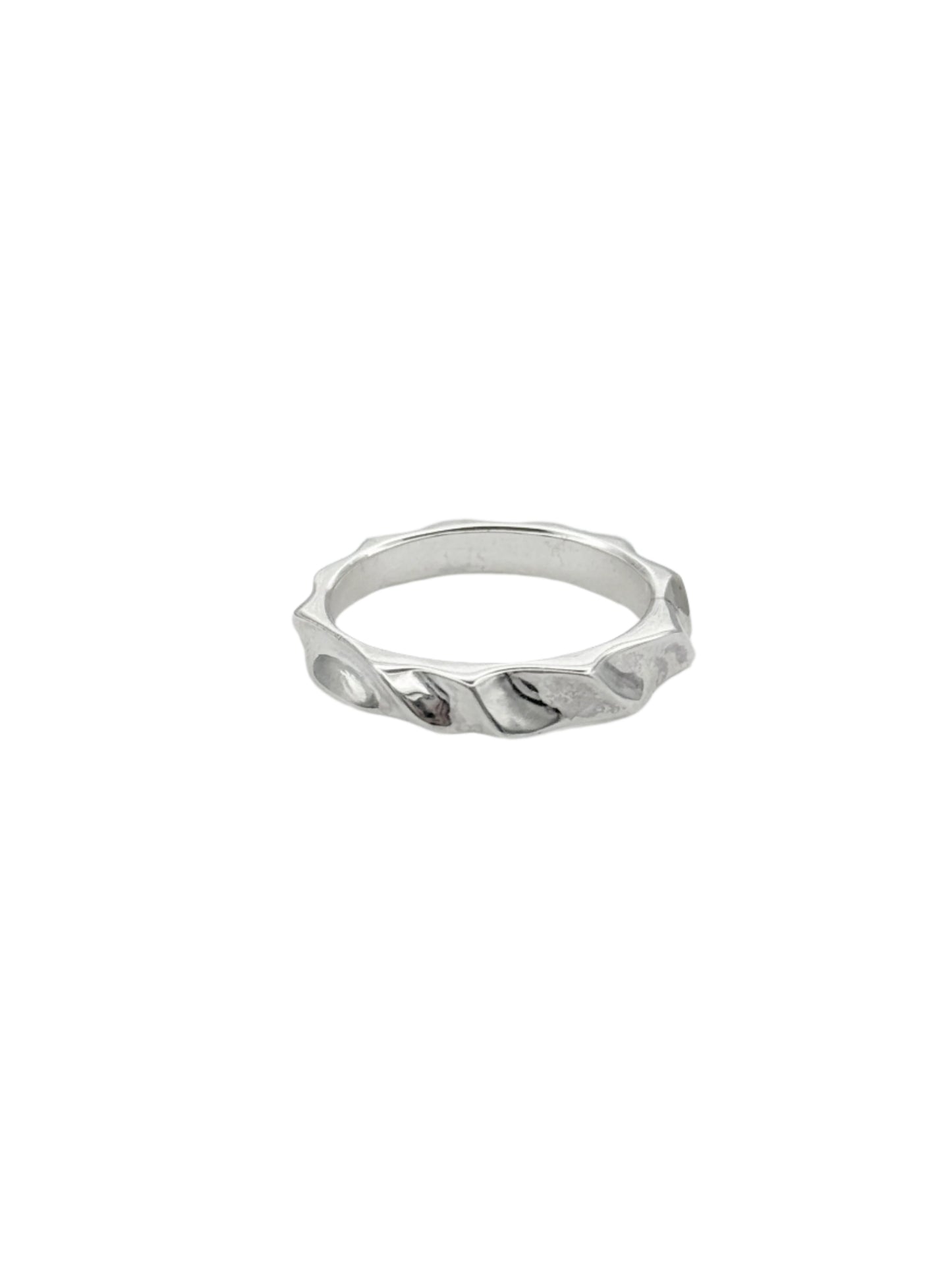 A silver ring with a hand-carved design featuring elegant curves and a rectangular profile.