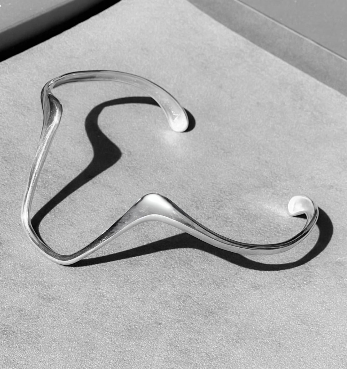 Silver hanger on a gray surface