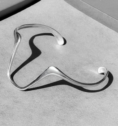 Silver hanger on a gray surface