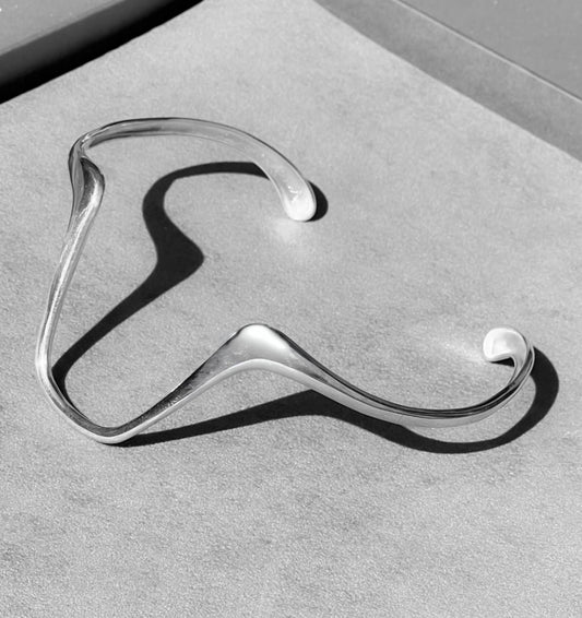 Silver hanger on a gray surface