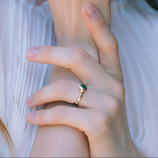 Girl model wearing gold rings with gemstones