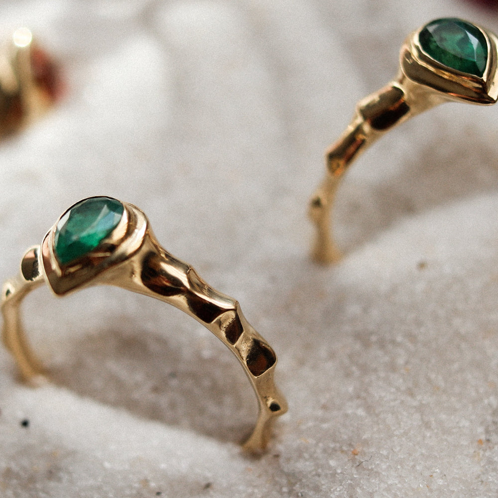 Yellow gold rings with pear cut emeralds