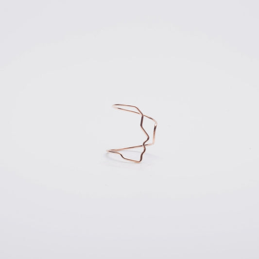 Rose gold hair clip on a light gray background