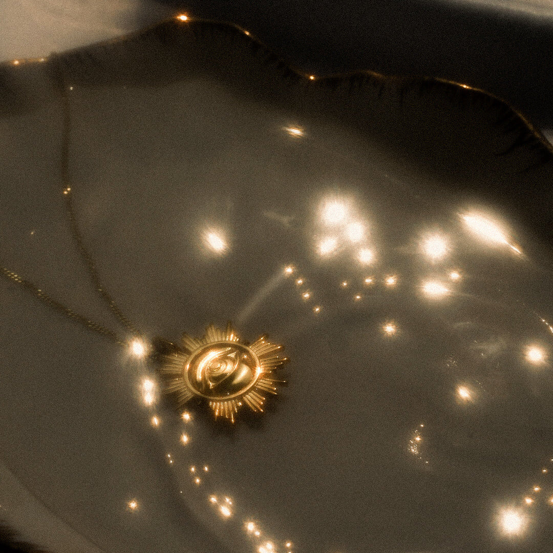 Gold star-shaped object on a reflective surface with light reflections