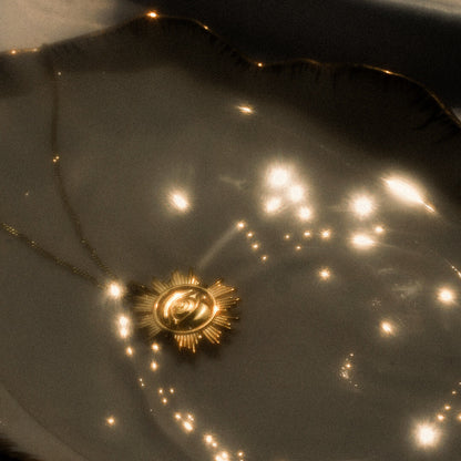 Gold star-shaped object on a reflective surface with light reflections