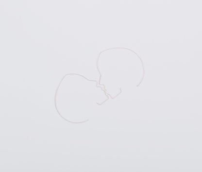 Two white heart-shaped balloons on a light gray background