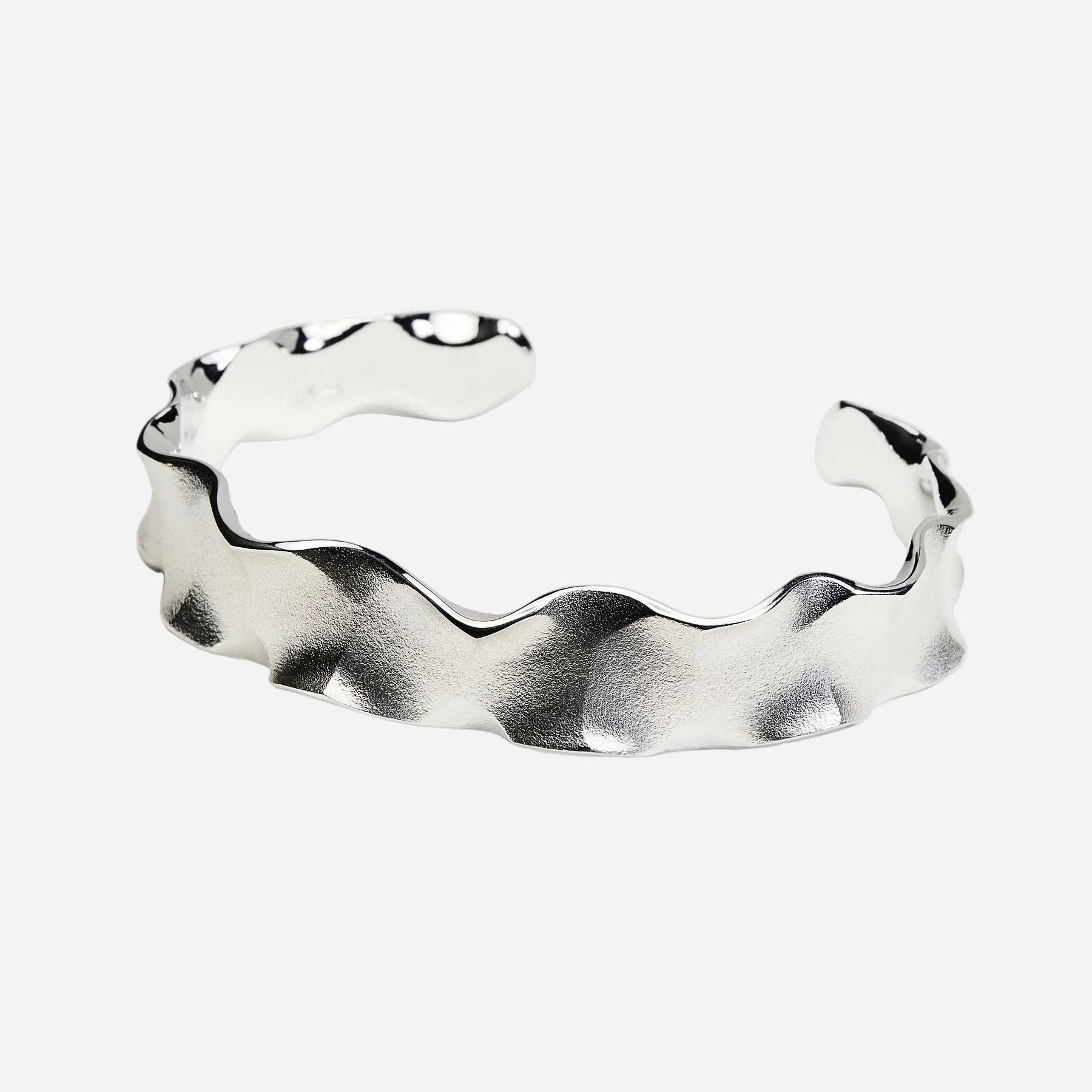 Silver wavy ring on a white background