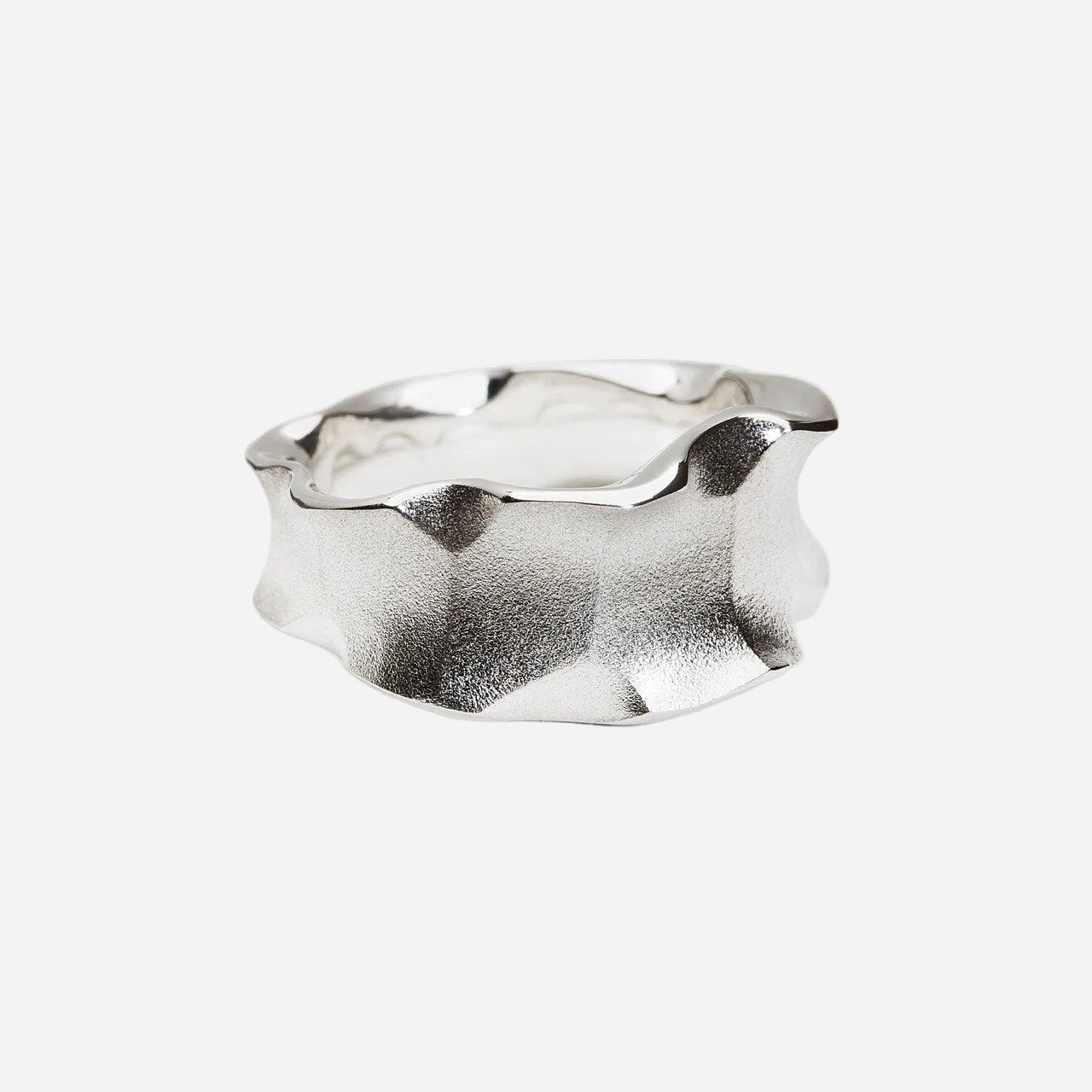 Silver ring with a wavy design on a white background
