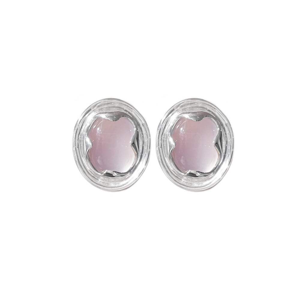 Pair of earrings with pink stones in silver settings on a white background