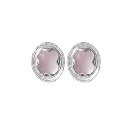 Pair of earrings with pink stones in silver settings on a white background