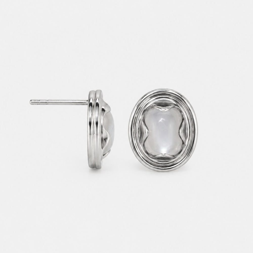 Pair of silver earstuds on a light gray background