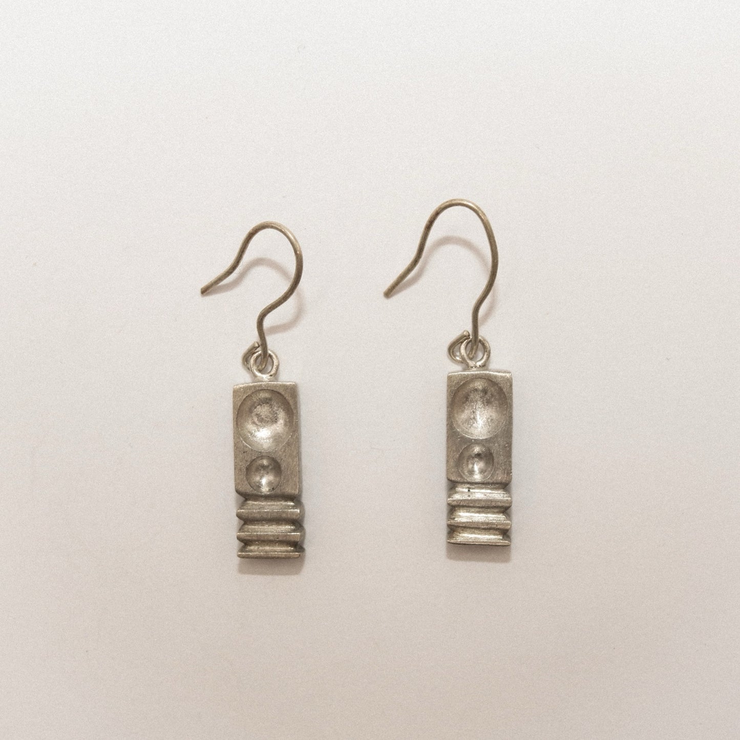 Pair of silver earrings on a white background