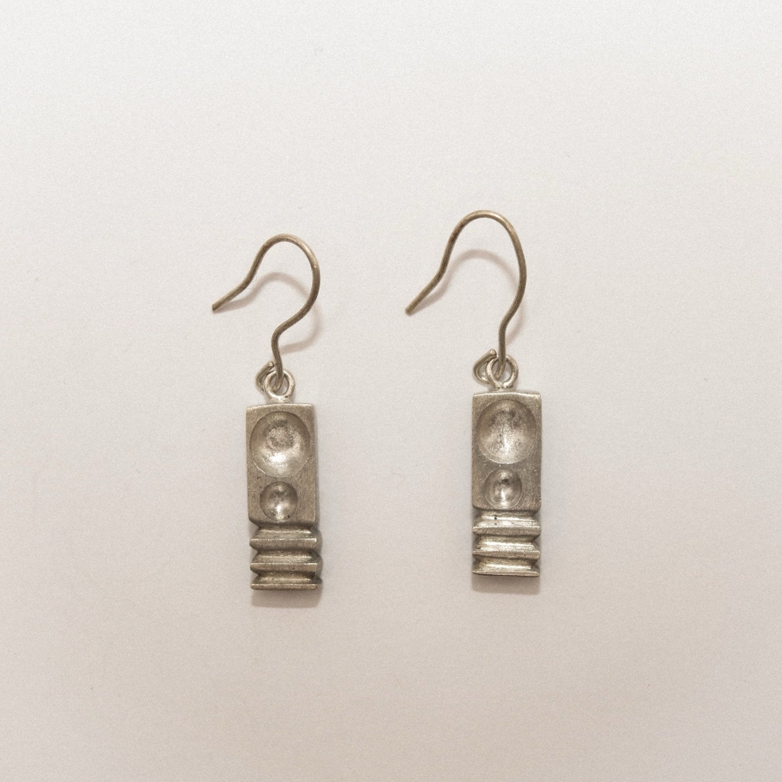 Pair of silver earrings on a white background