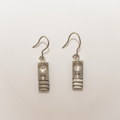 Pair of silver earrings on a white background
