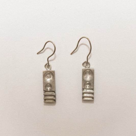 Pair of silver earrings on a white background
