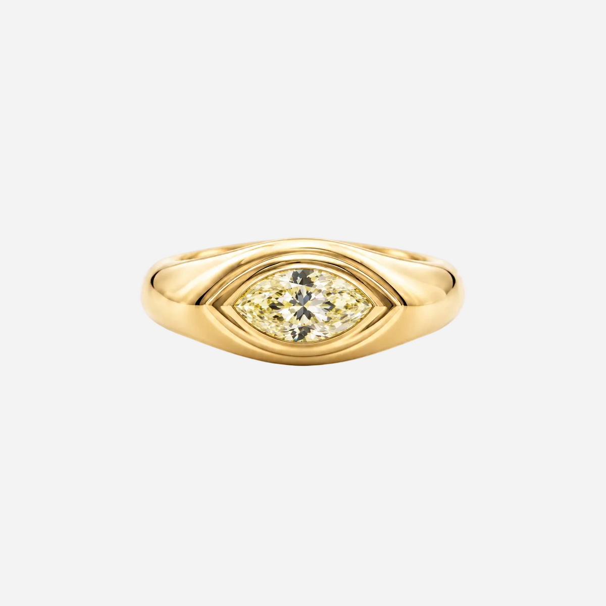 A yellow gold eye-shaped ring featuring a marquise-cut yellow diamond in the center, set against a plain light gray background.