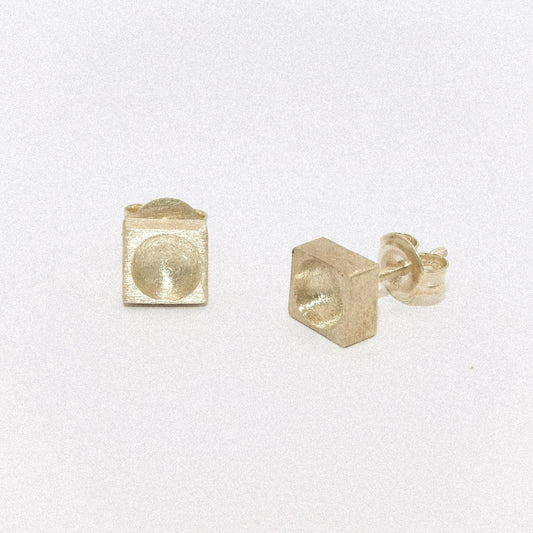 Gold square stud earrings on a white background