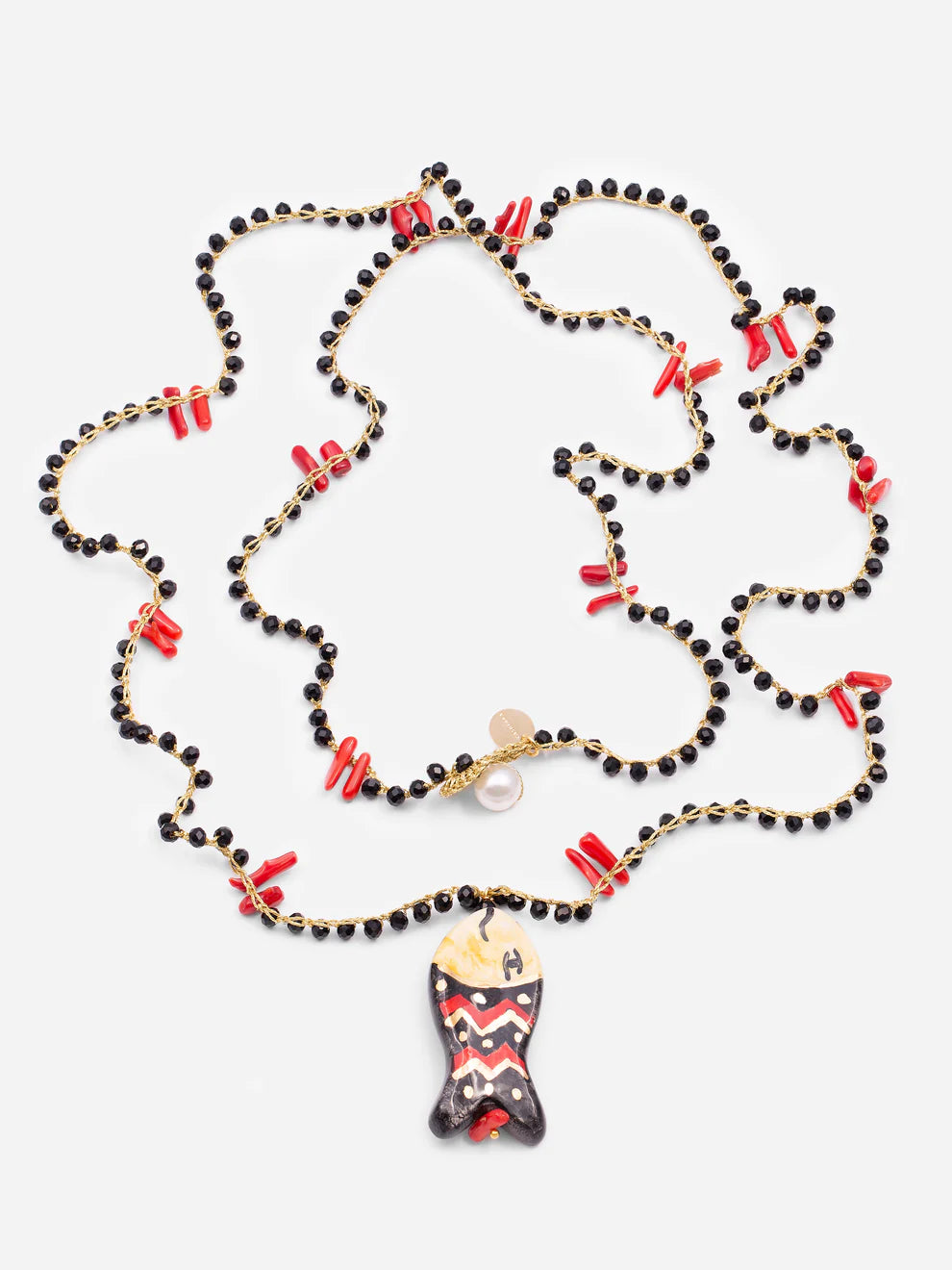 Necklace with black beads, red accents, and a unique pendant on a white background