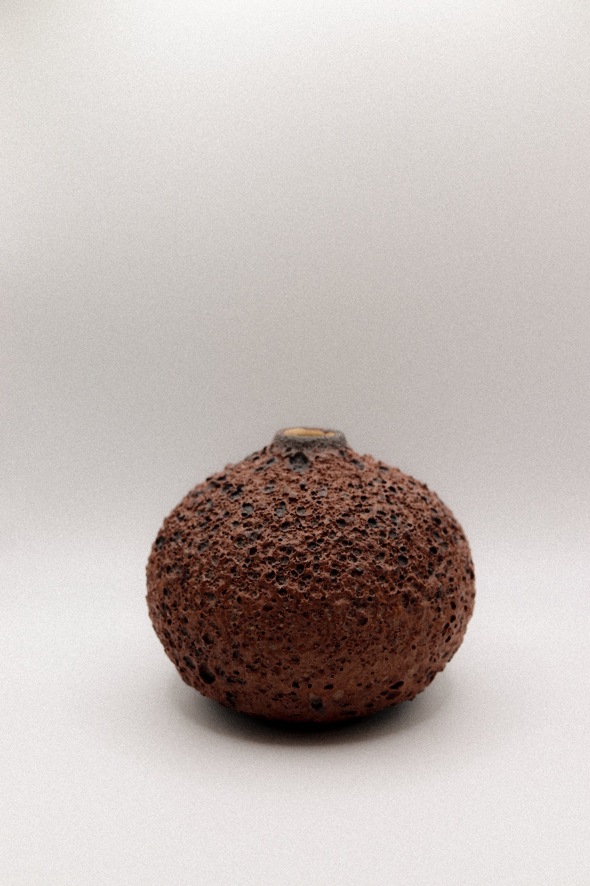 Brown textured ceramic vase on a white background