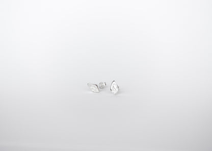 Pair of silver earrings on a light gray background