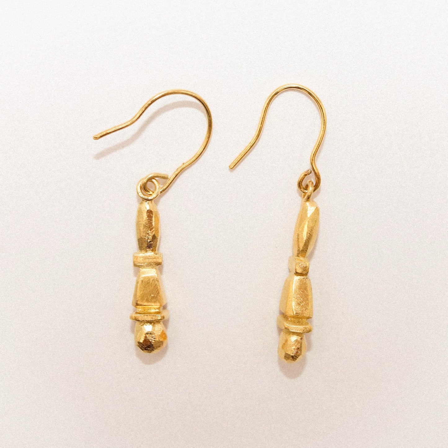 Gold earrings on a white background