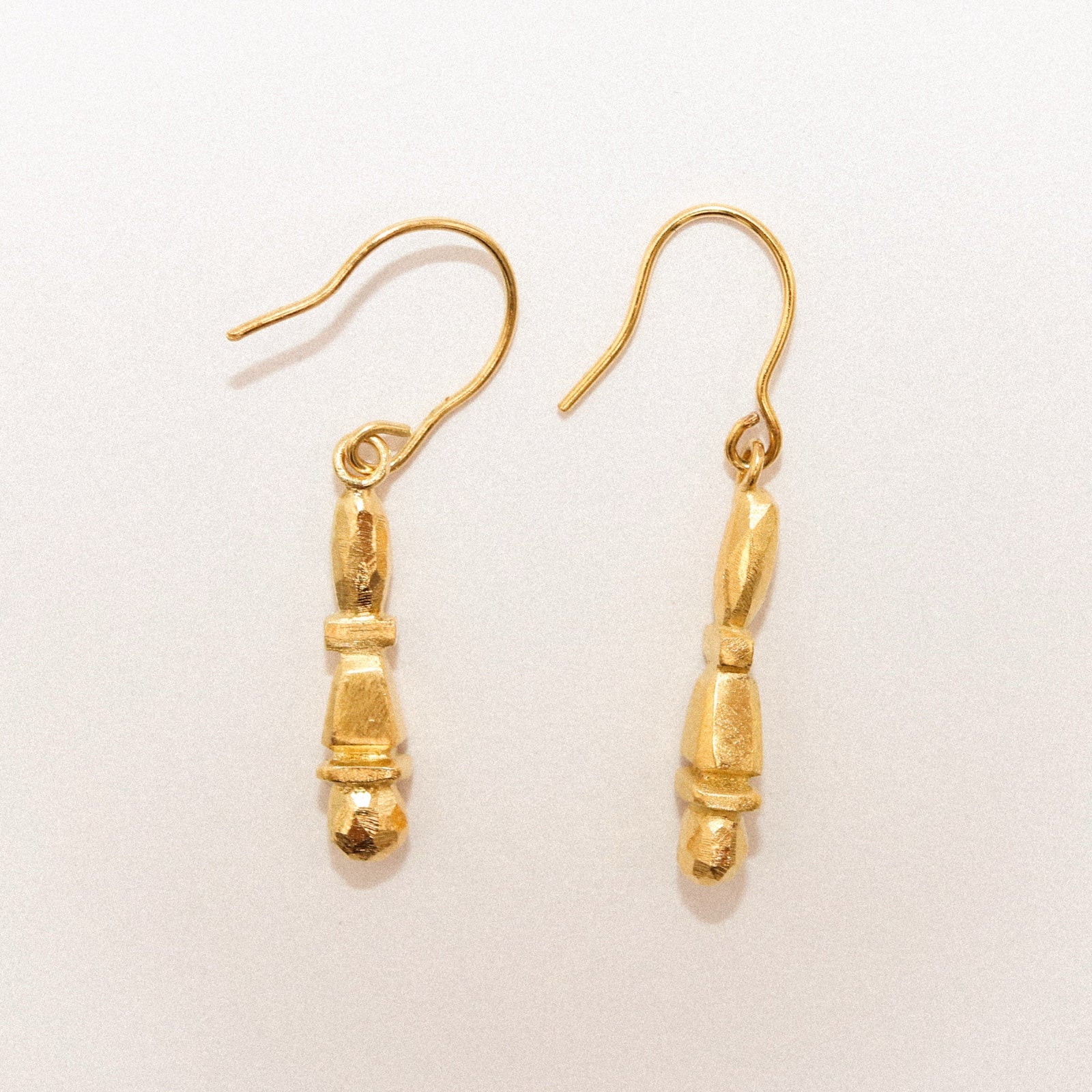 Gold earrings on a white background