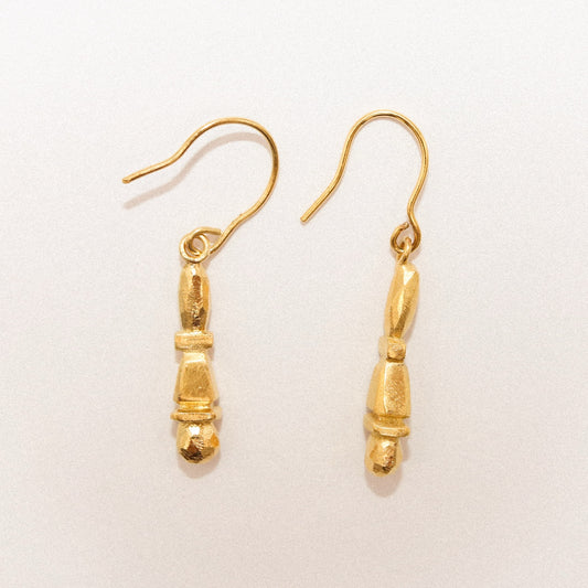 Gold earrings on a white background