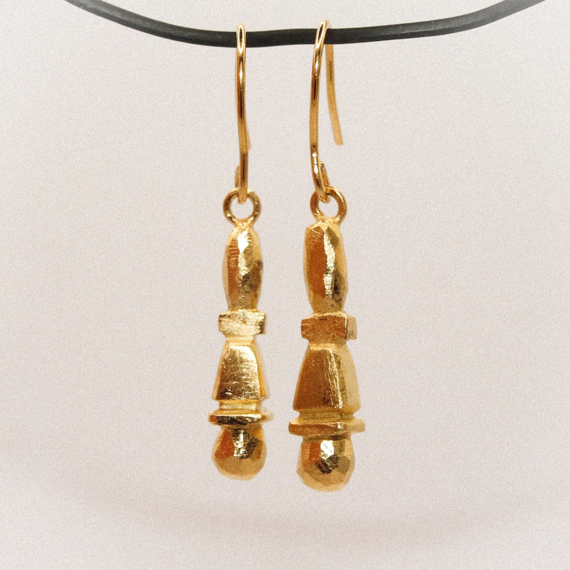 Gold earrings on a white background