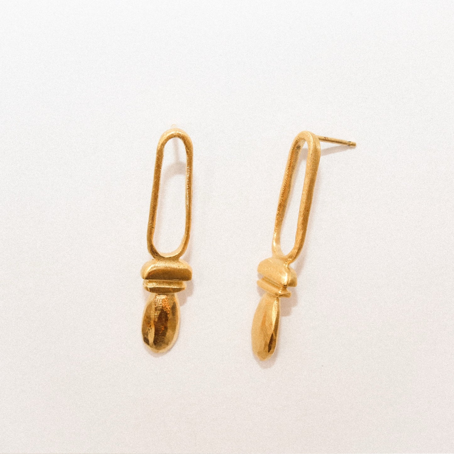Pair of gold earrings on a white background