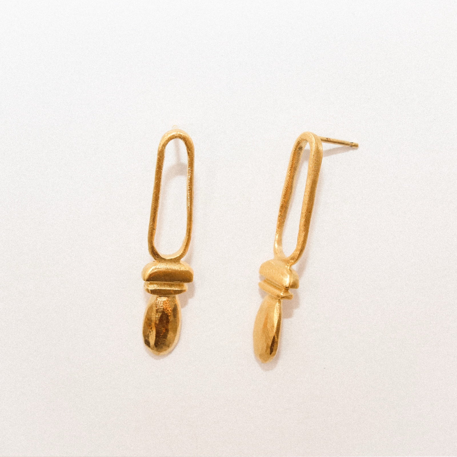 Pair of gold earrings on a white background