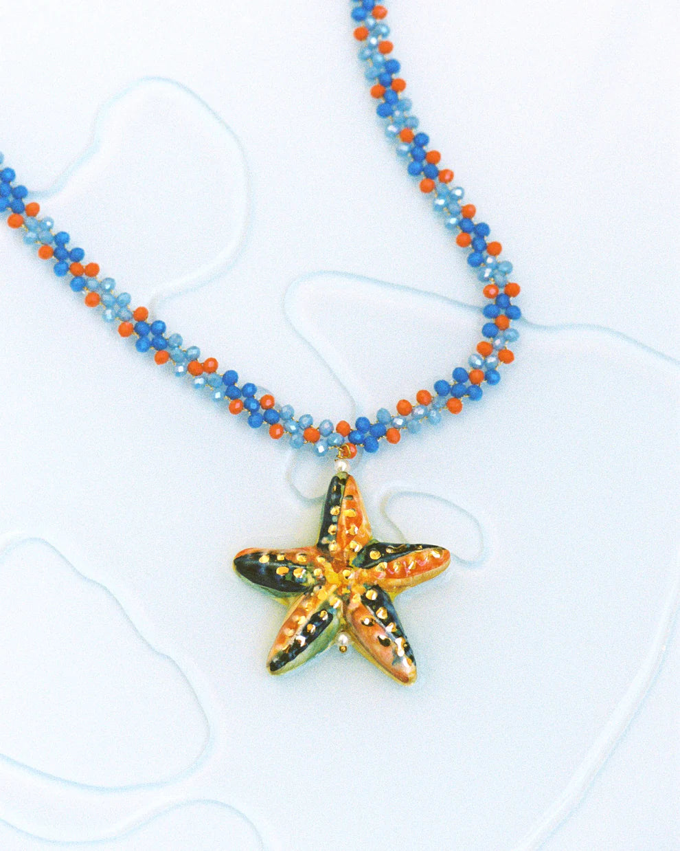 Necklace with a starfish pendant on a white background
