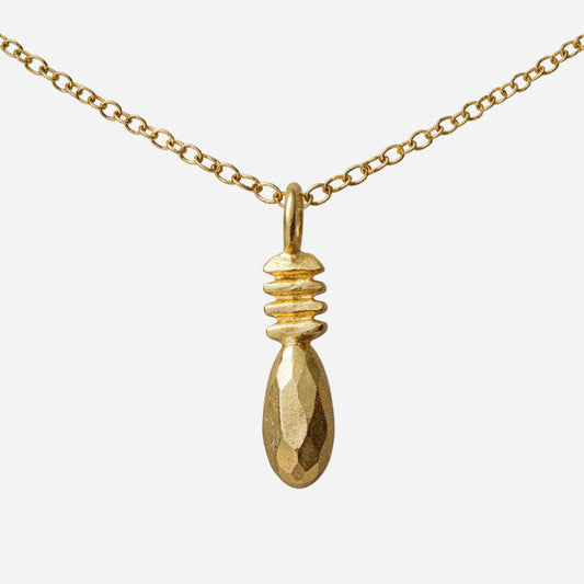 Gold necklace with a pendant on a white background