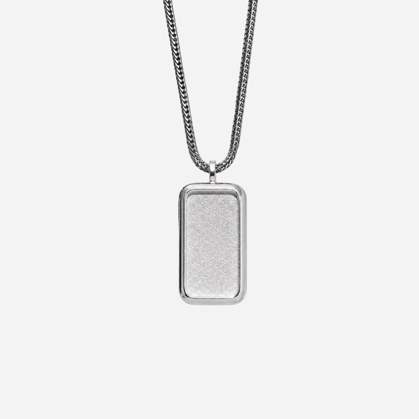 Silver rectangular pendant on a chain against a white background