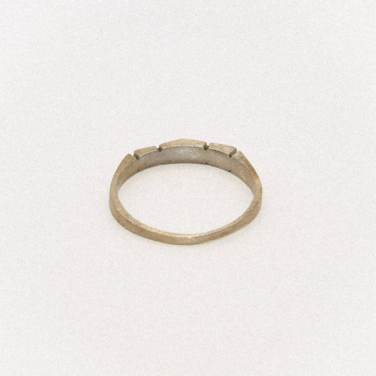 Silver ring with a textured band on a white background