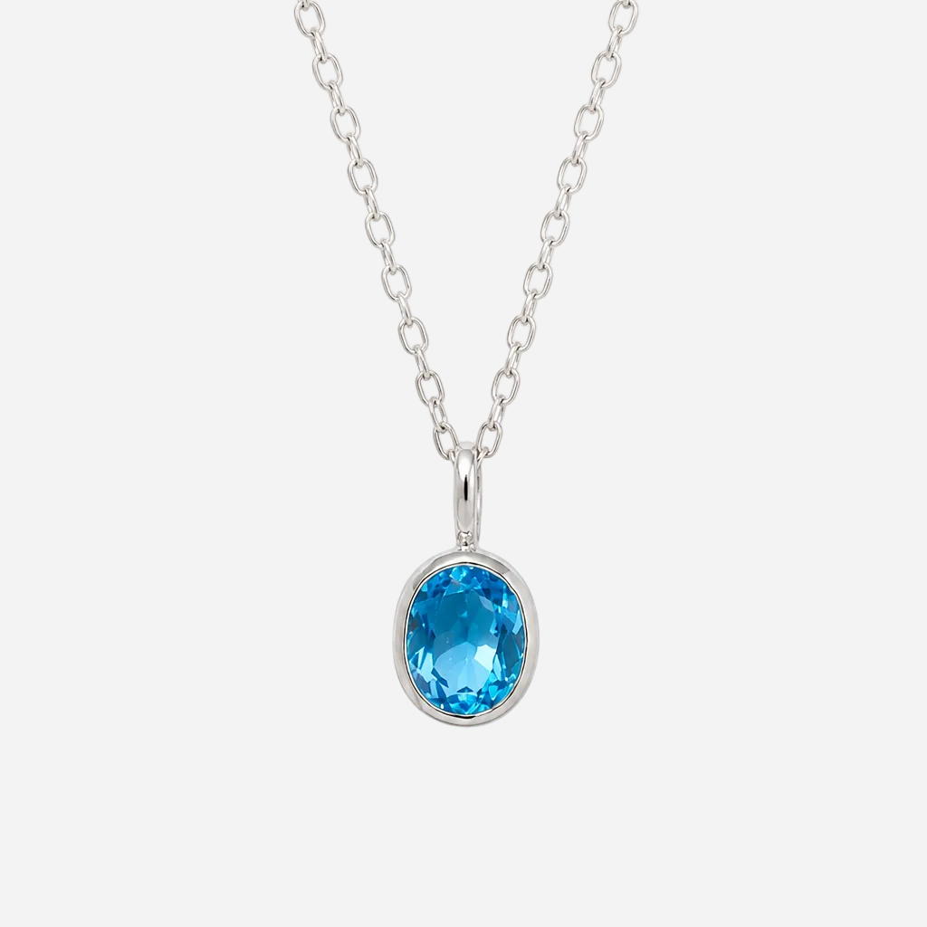 A silver chain necklace with an oval-cut bright blue gemstone pendant in a bezel setting, shown against a plain white background.