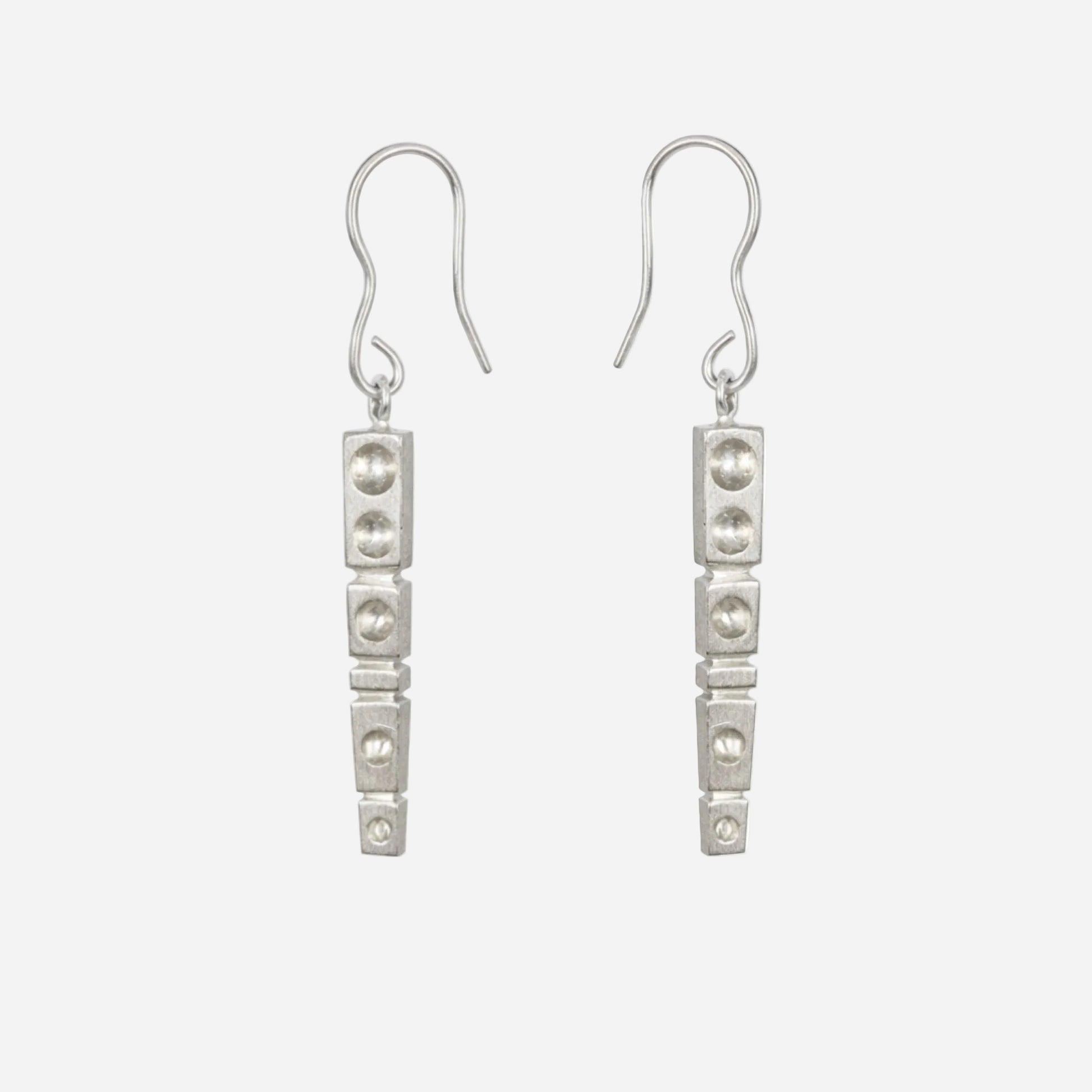 Pair of silver earrings on a white background