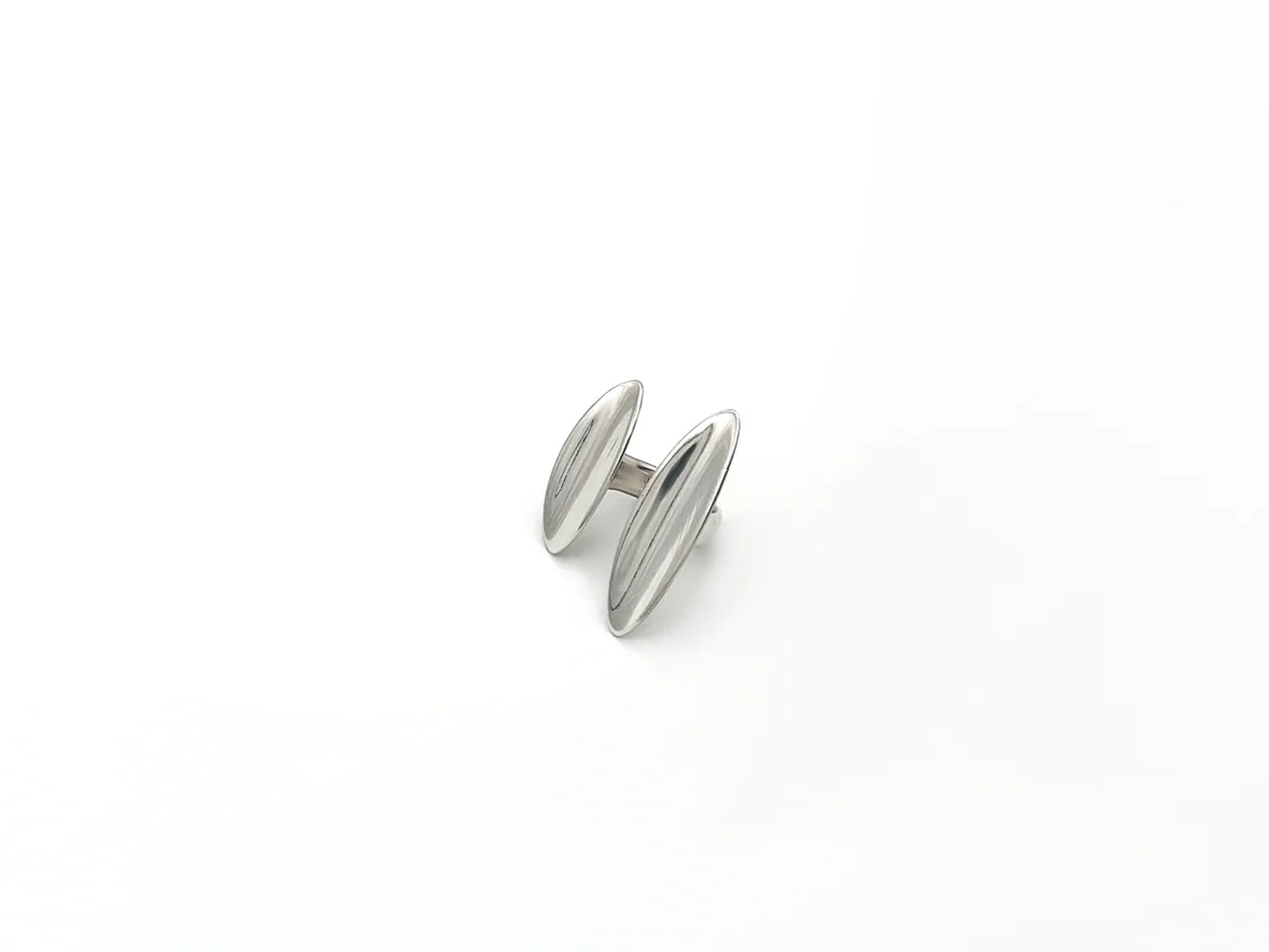 Silver cufflink on a white background