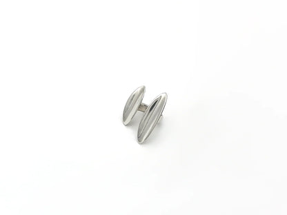 Silver cufflink on a white background