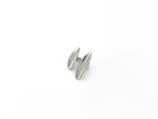 Silver cufflink on a white background
