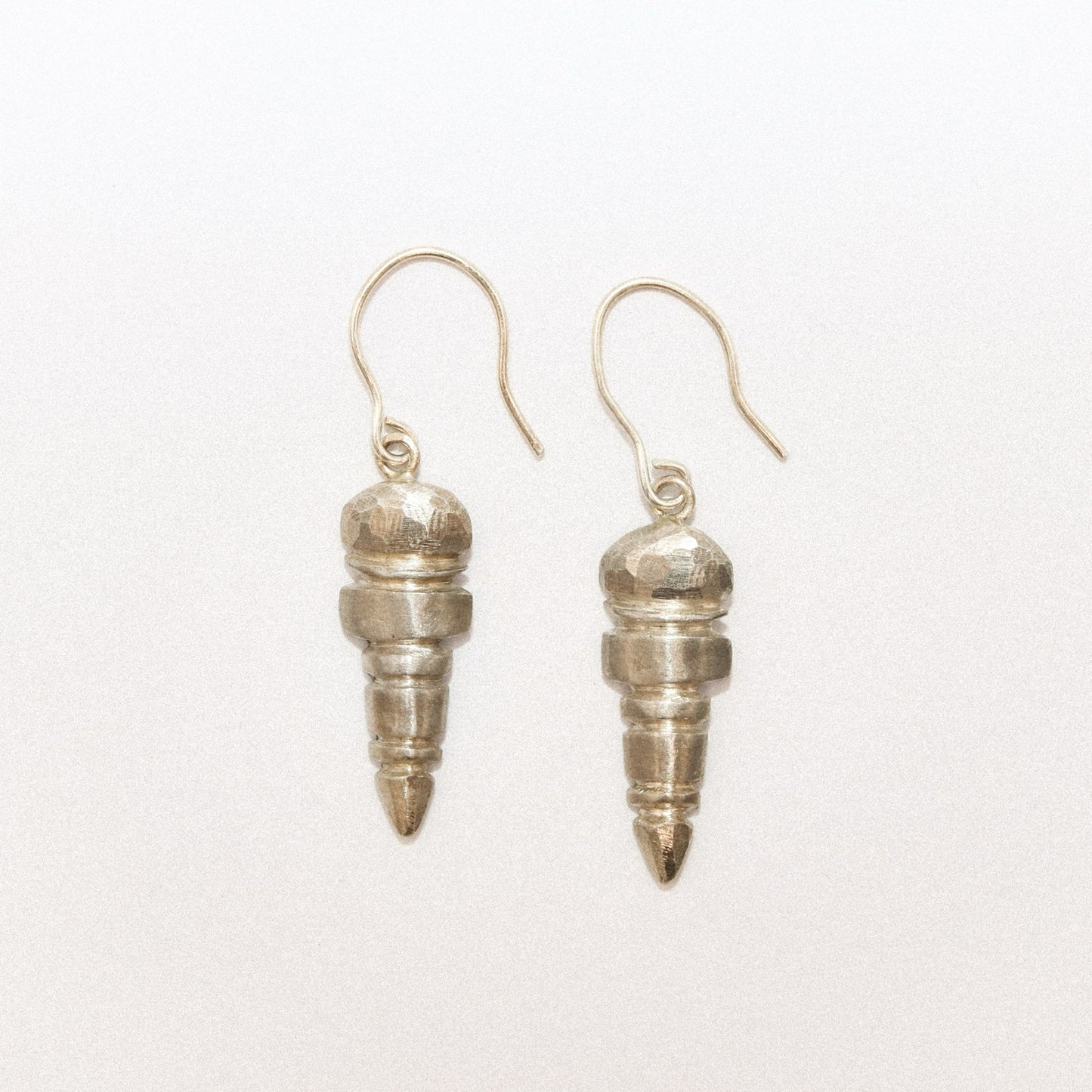 Silver spiral earrings on a white background
