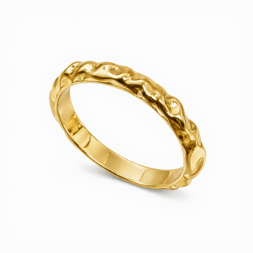 Gold ring with a textured design on a white background