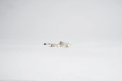 Silver bracelet on a light gray background